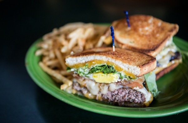 Grilled Cheese Burger with a Fried Egg, Bacon, Arugula, and two cheeses. Photo by Michael Lee.